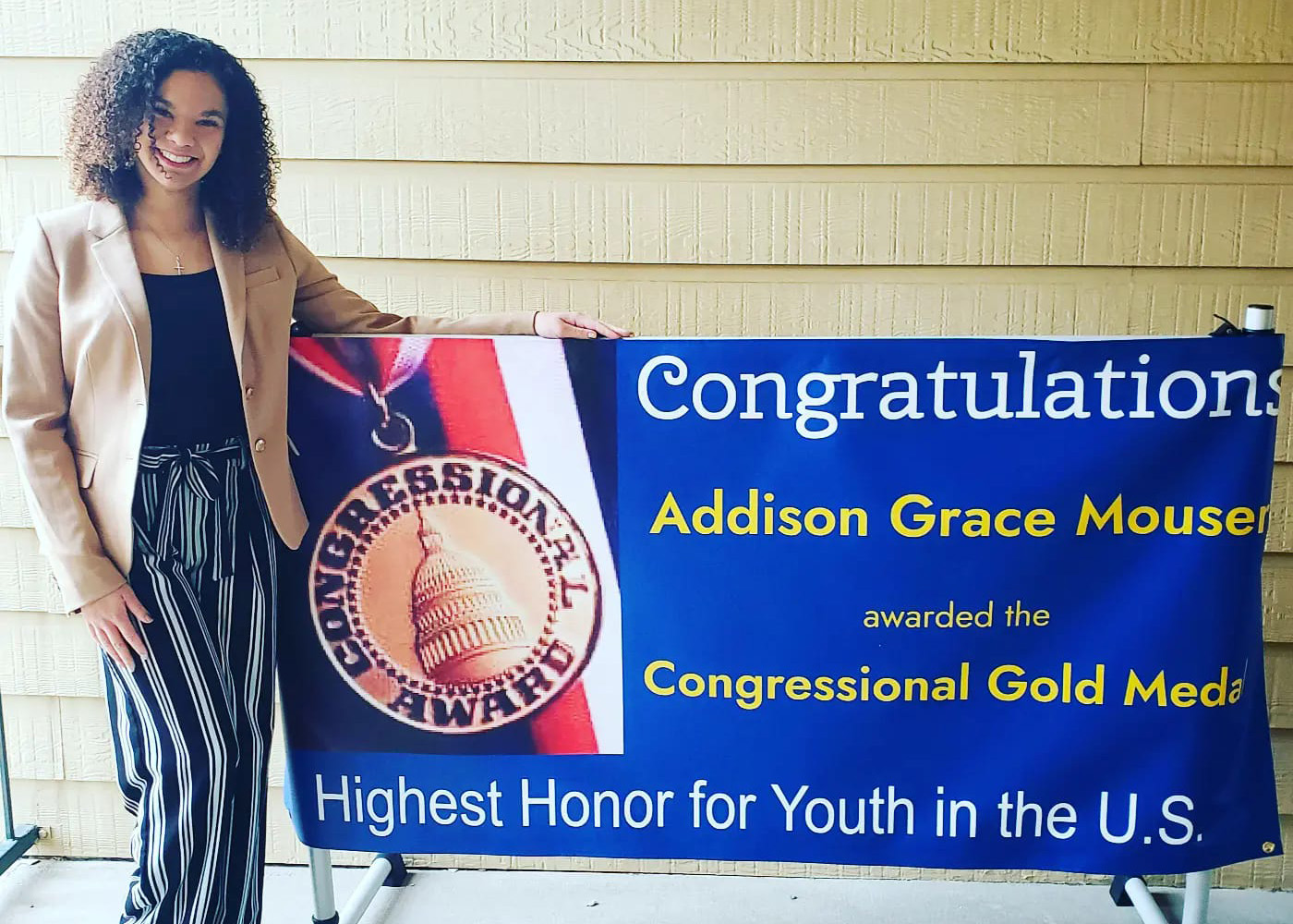 Addison with a celebration banner