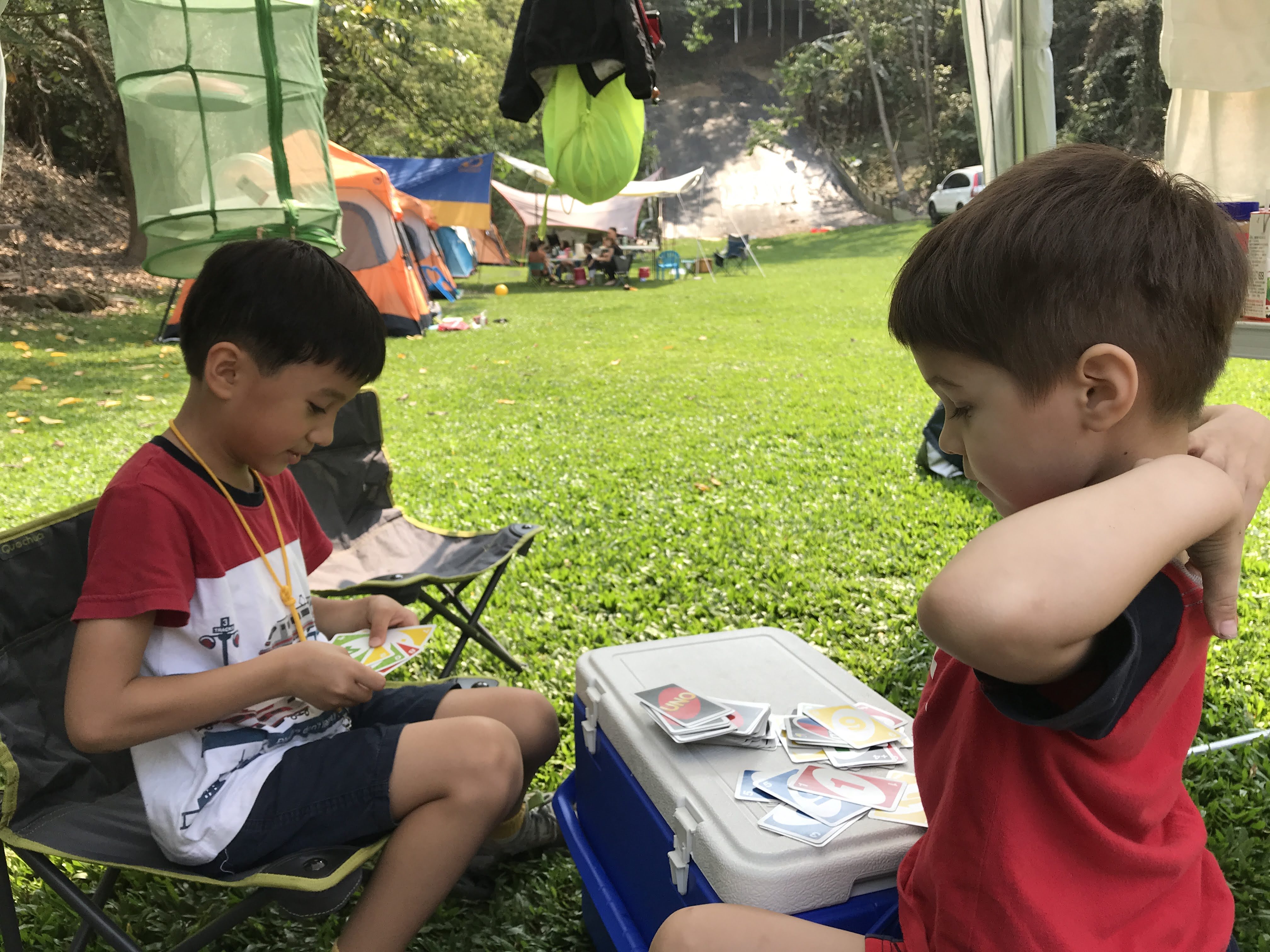 Robert's son playing Uno outside in the summer