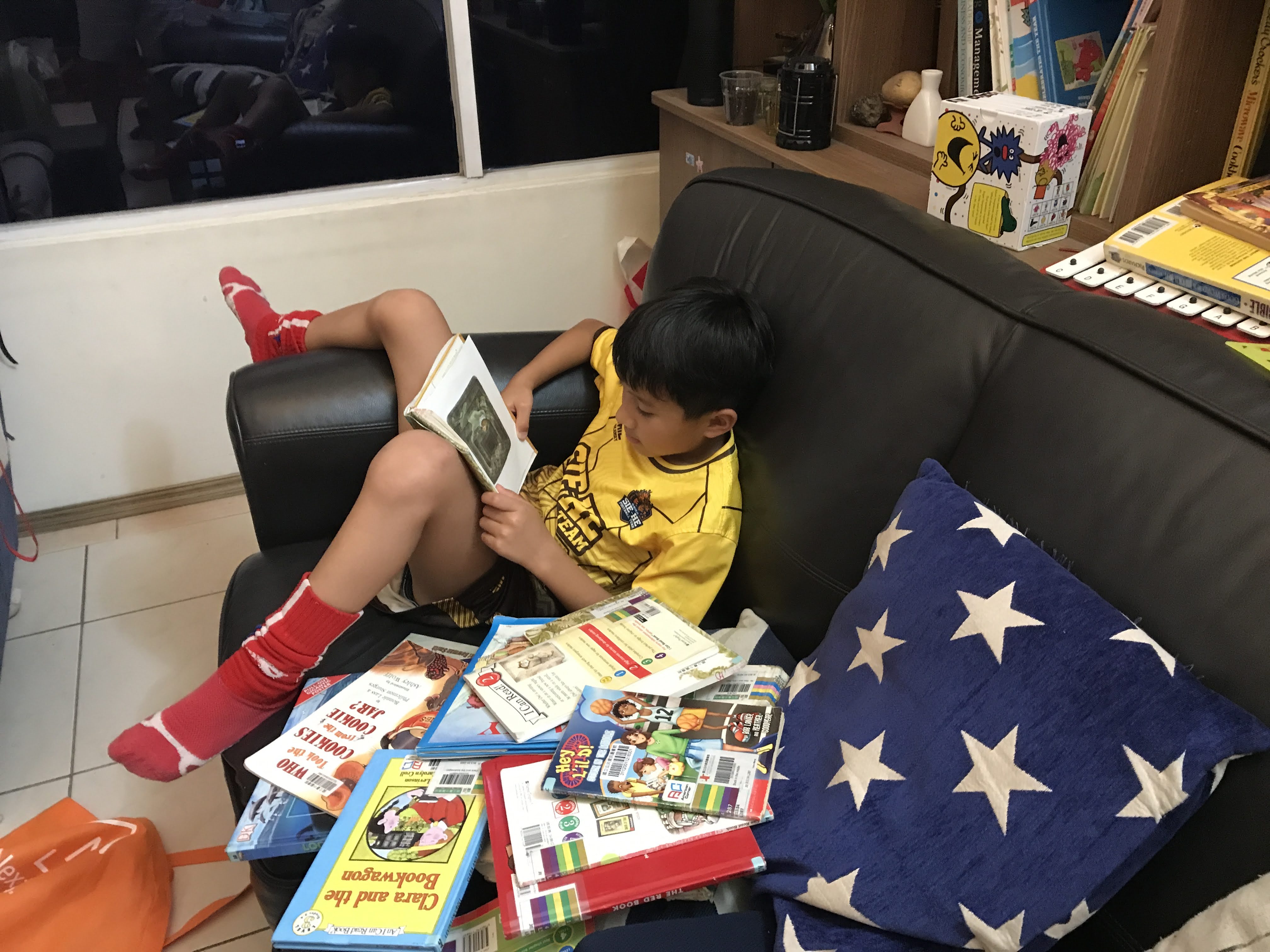 Robert's son reading on the couch