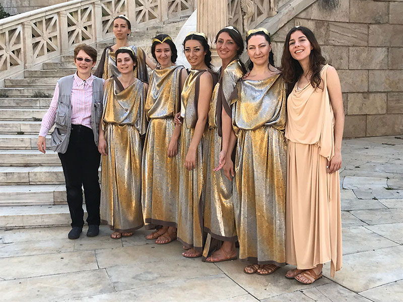 A Greek troupe pose for a group shot after filming.