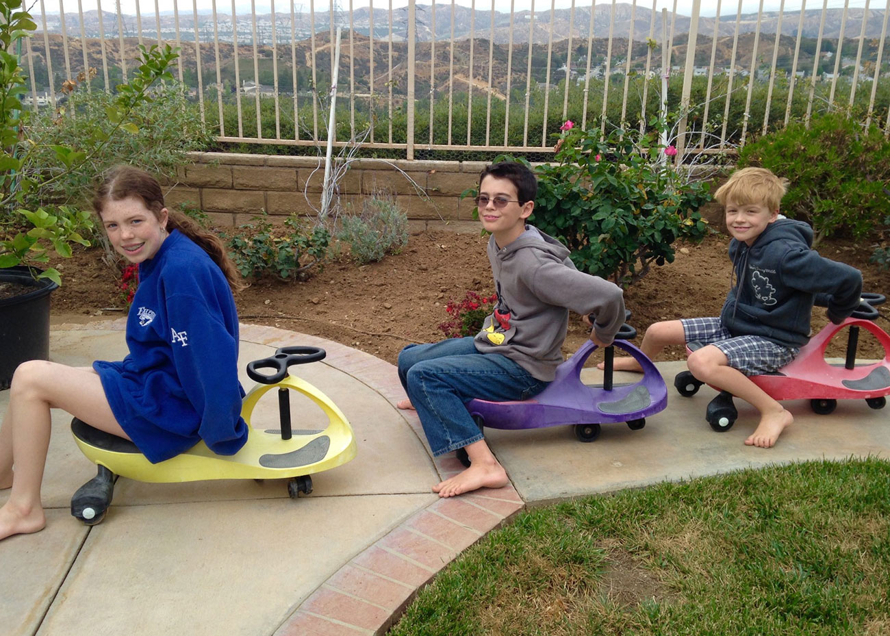 Rachael, Joshua, and Michael on scooters